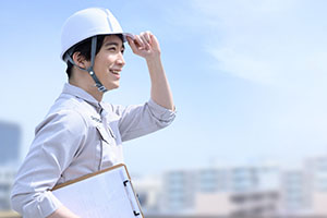 街を眺める作業員男性